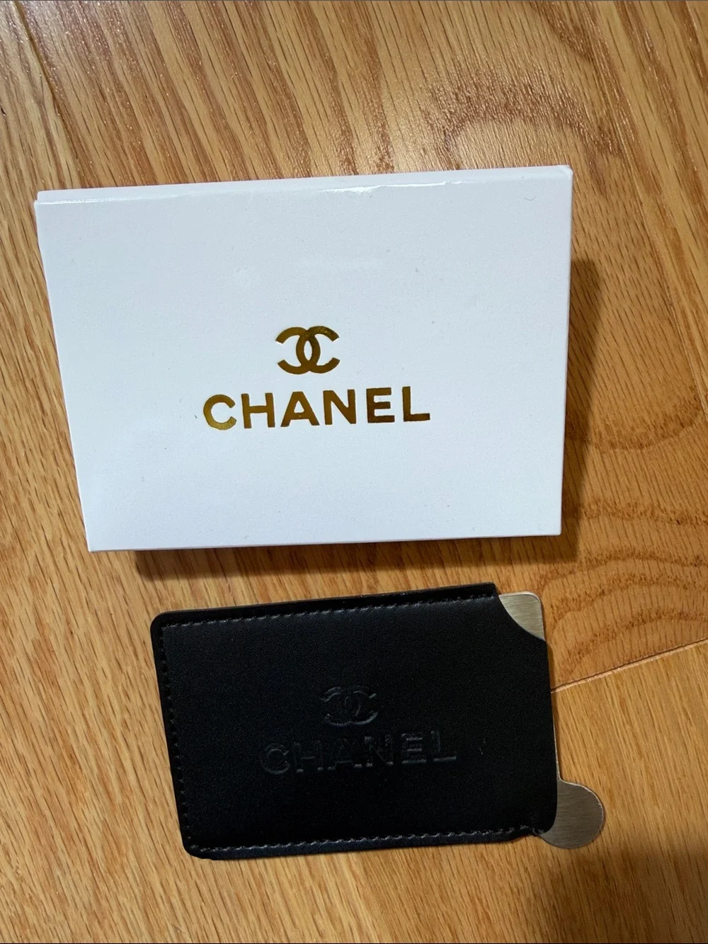 Chanel black card case with mirror.